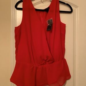 Sleeveless, peplum style top.